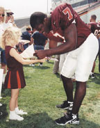 Vick signs autograph for young fan