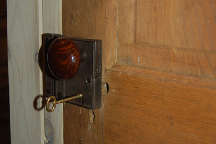 four-panel door with rim locks and porcelain knobs