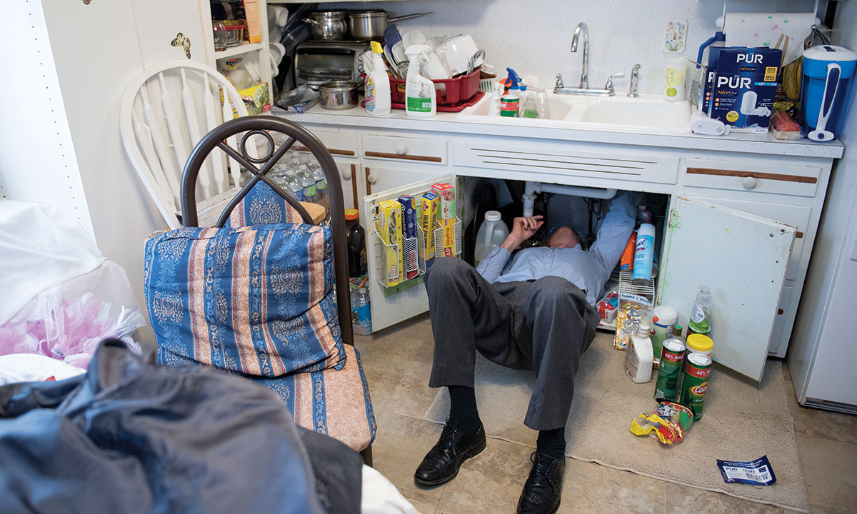 Marc Edwards inspecting pipes in a Flint home