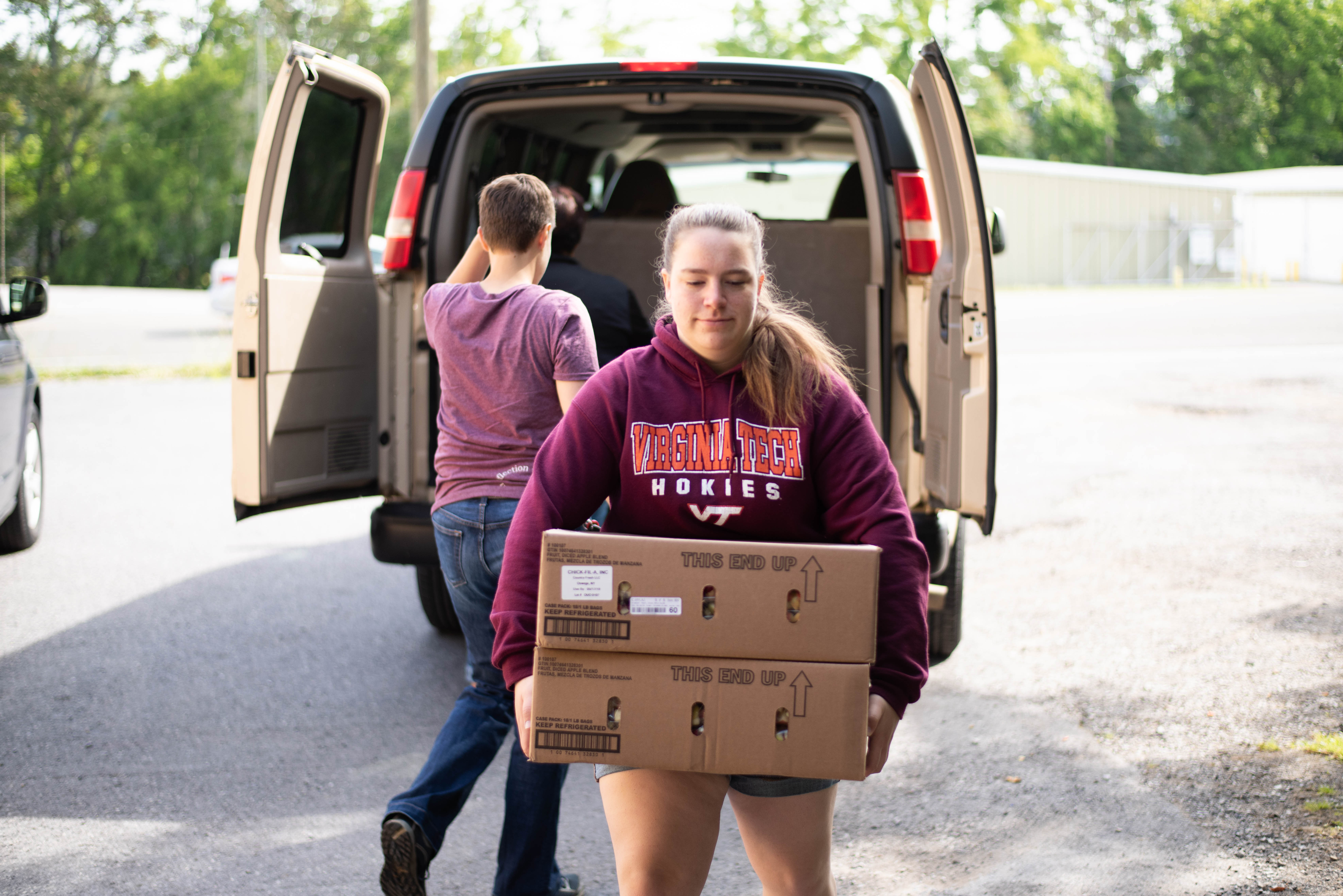 student carrying a box