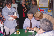 Homer signing books for friends and neighbors