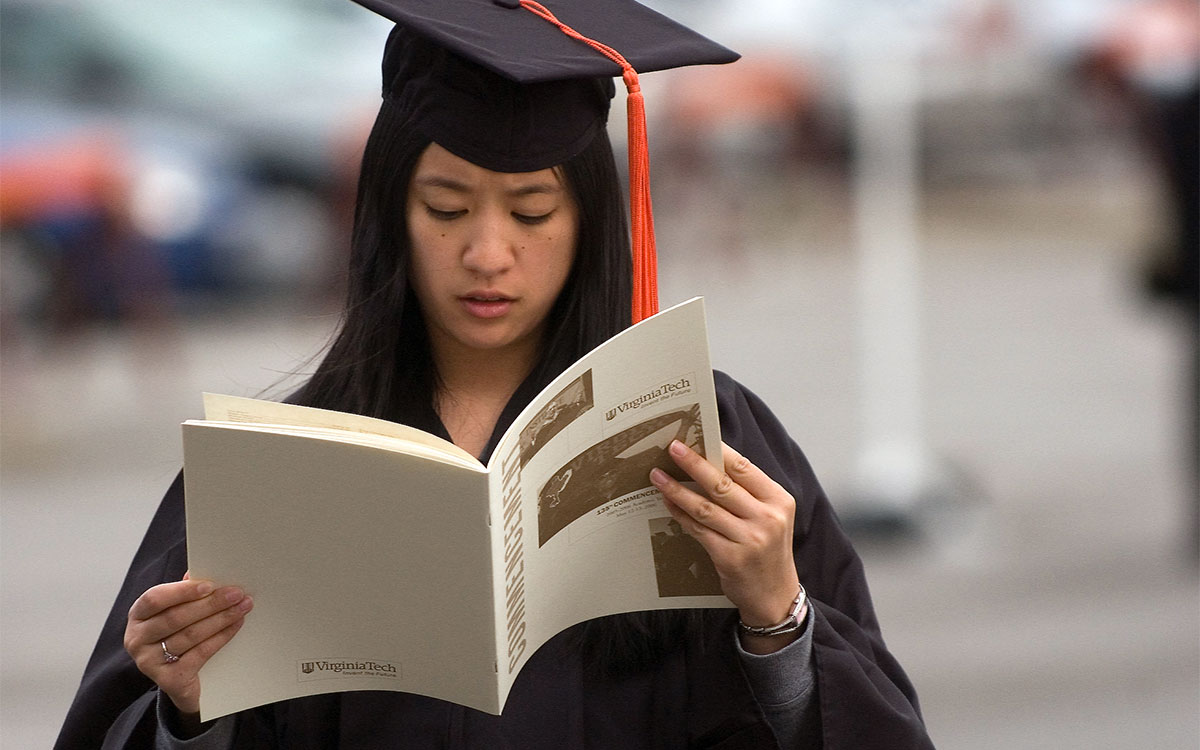 Virginia Tech student with commencement program