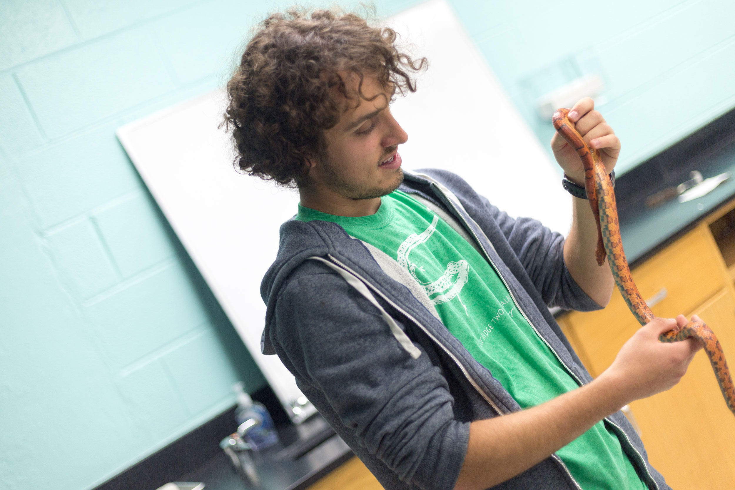 Student in the museum with a snake