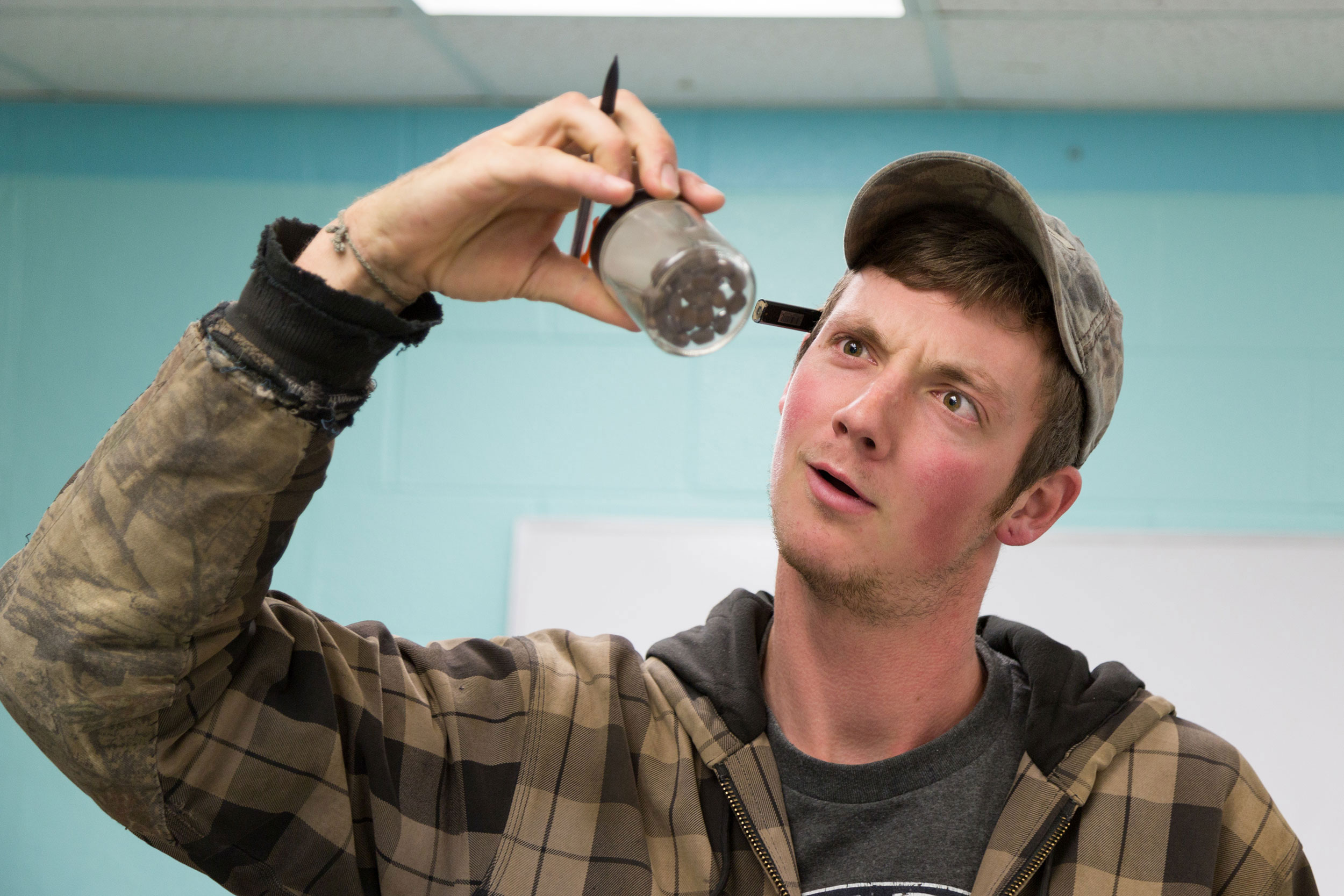 Student looking at a specimen in a jar