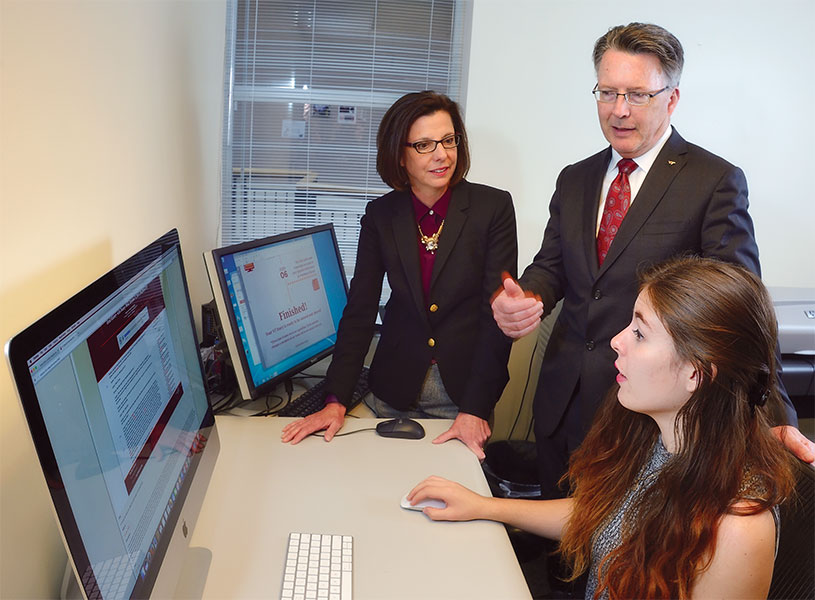 Virginia Tech President Tim Sands and Dr. Laura Sands with senior Ashley Stant